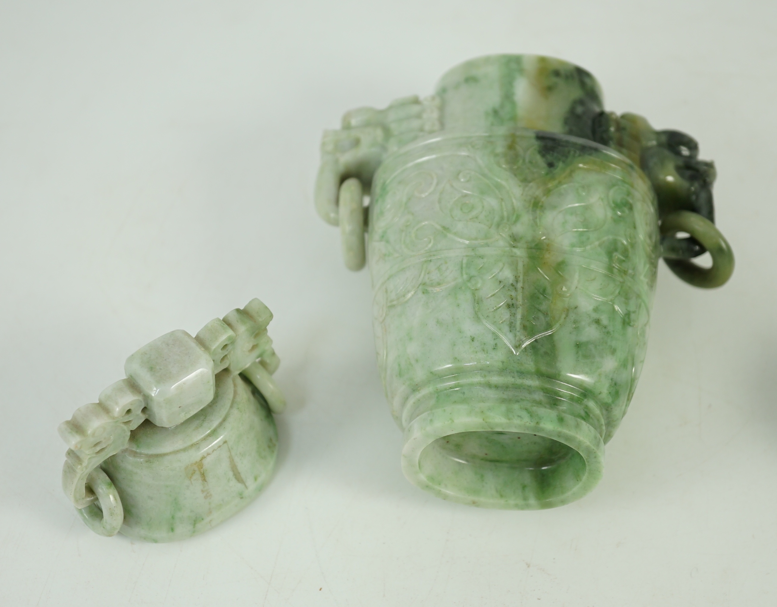 A Chinese archaistic jadeite two-handled vase and cover, first half 20th century, 16 cm high, excluding wood stand